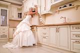 beautiful bride stands in the kitchen