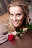 Pretty young girl with a red rose