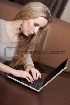 Young blonde girl working on a computer