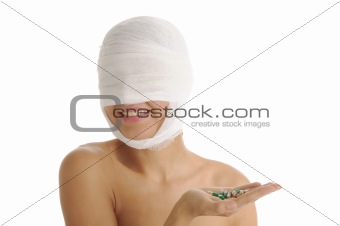 woman in bandages holding capsules