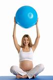 Pregnant woman practicing yoga with ball