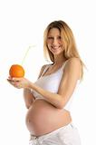 pregnant woman holding orange with straw
