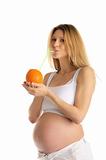pregnant woman drinking juice from the orange
