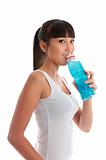 Attractive girl drinking sports drink after exercise