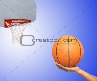 Basketball in hand and basket isolated on white