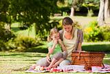 Mother and her daughter picnicking in the park