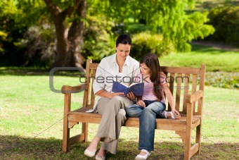 Mother and her daughter reading a book