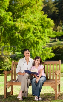 Mother and her daughter reading a book