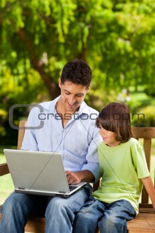 Son with his father looking at their laptop