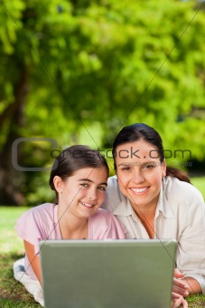 Mother and her daughter looking at their laptop