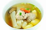 Vegetable soup with pork in white bowl 