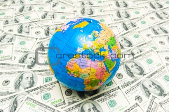Globe over many american dollar bank notes