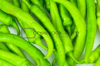 Green peppers in the plate isolated on white