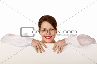 Young happy woman leans on blank billboard