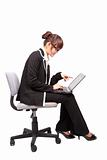 Business woman using laptop on the chair