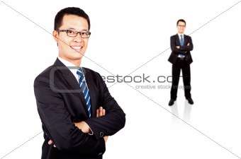 Portrait of a smiling young businessman standing against isolated white background
