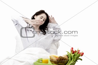 young woman yawning before breakfast