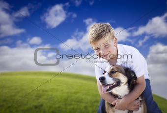 Handsome Young Boy Playing with His Dog on a Lush Green Grass Field.