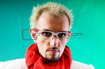 Man with red scarf against coloured background