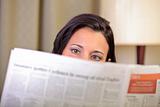 View of woman's eyes reading the newspaper