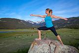 Woman practices yoga in the mountains