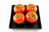 four tomatoes on a tray