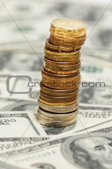 Stack of coins on the dollar background