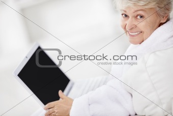 Mature woman smiling with laptop