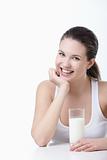 Smiling girl with a glass of milk