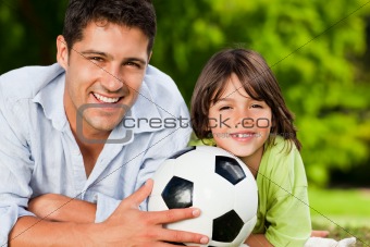 Father and his son with their ball in the park