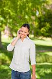 Young woman phoning in the park 