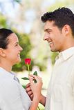 Happy man offering a rose to his girlfriend