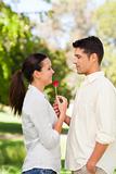 Happy man offering a rose to his girlfriend