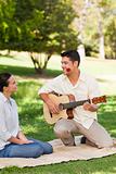 Man playing guitar for his girlfriend