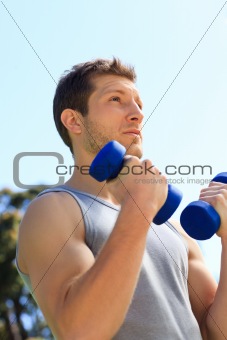 Young man doing his exercises in the park