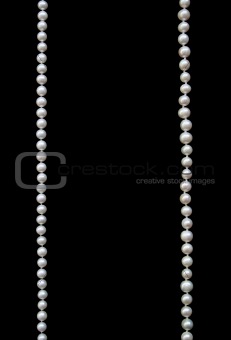 White pearls on the black silk 