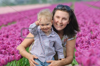 In Tulip Field. Mother with son in tulips field
