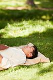 Man lying in the park with his book
