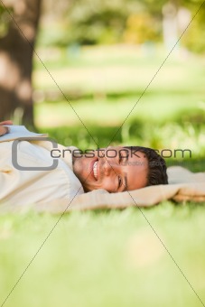 Man lying in the park with his book