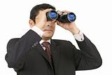 Businessman searching with binoculars