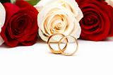 Roses and wedding rings isolated on the white