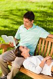 Man reading a book with his girlfriend