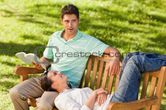 Man reading a book with his girlfriend