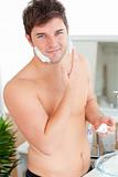 Attractive caucasian man ready to shave in the bathroom