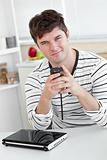 Smiling man sending a text message with his cellphone in front o
