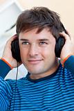 portrait of a handsome man listening music with earphones