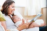 Charming mother showing images in a book to her cute little son