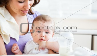 Portrait of a charming mother taking care of her adorable baby i