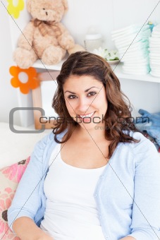 Smiling young mother sitting on a sofa