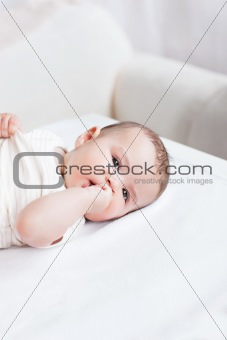 Portrait of a cute baby lying on table in the living-room